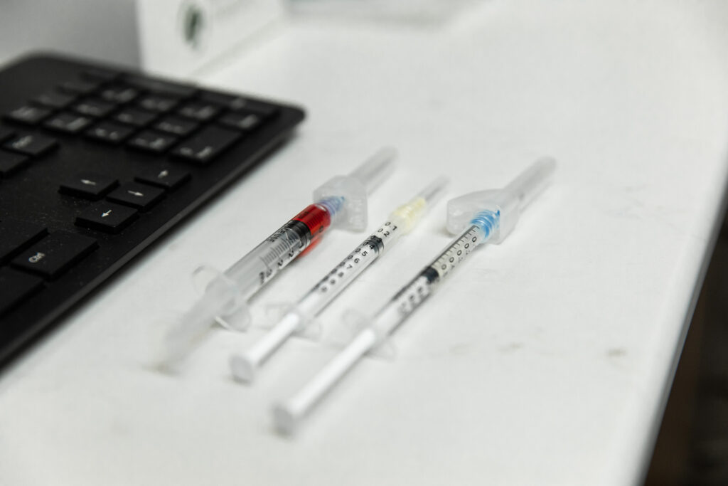 A close-up of 3 filled hypodermics containing vitamin and nutrient supplements. These are being used for a guest receiving weight loss support in River North, Chicago.